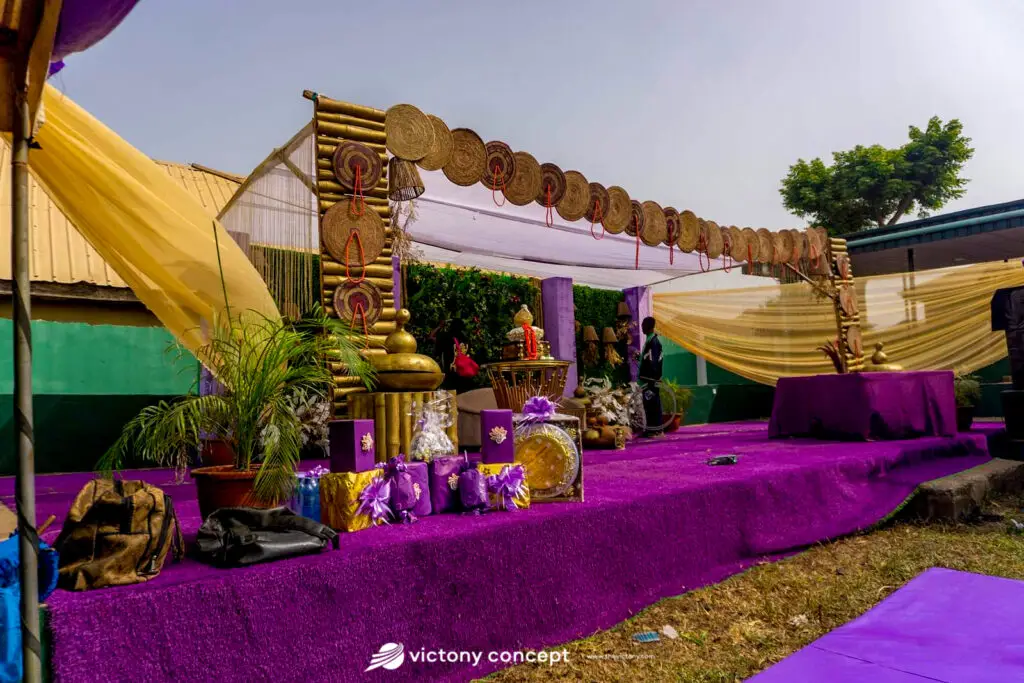 Purple and gold traditional wedding stage decor with woven canopy, styled by Victony Event Planners